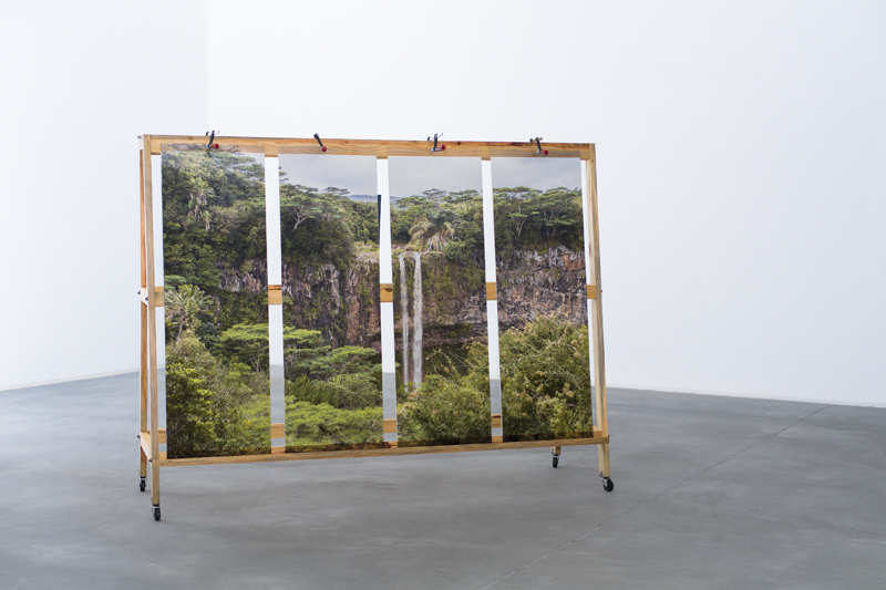 Lost paradise, 2014 Wood Eas el , Metal clamps, Wheels , glass, Inkjet print over Vynil ,  Variable dimensions,